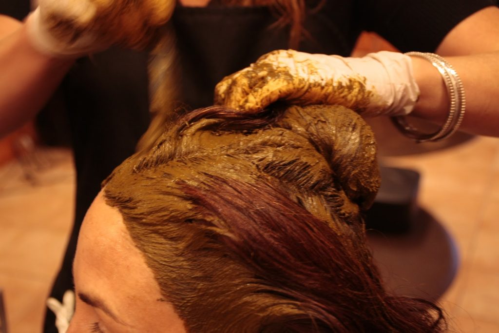 Applying Henna Dye Paste on Hairs